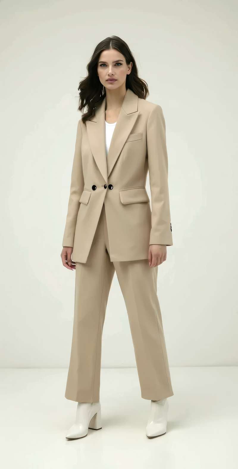 Woman wearing a beige suit with a white background